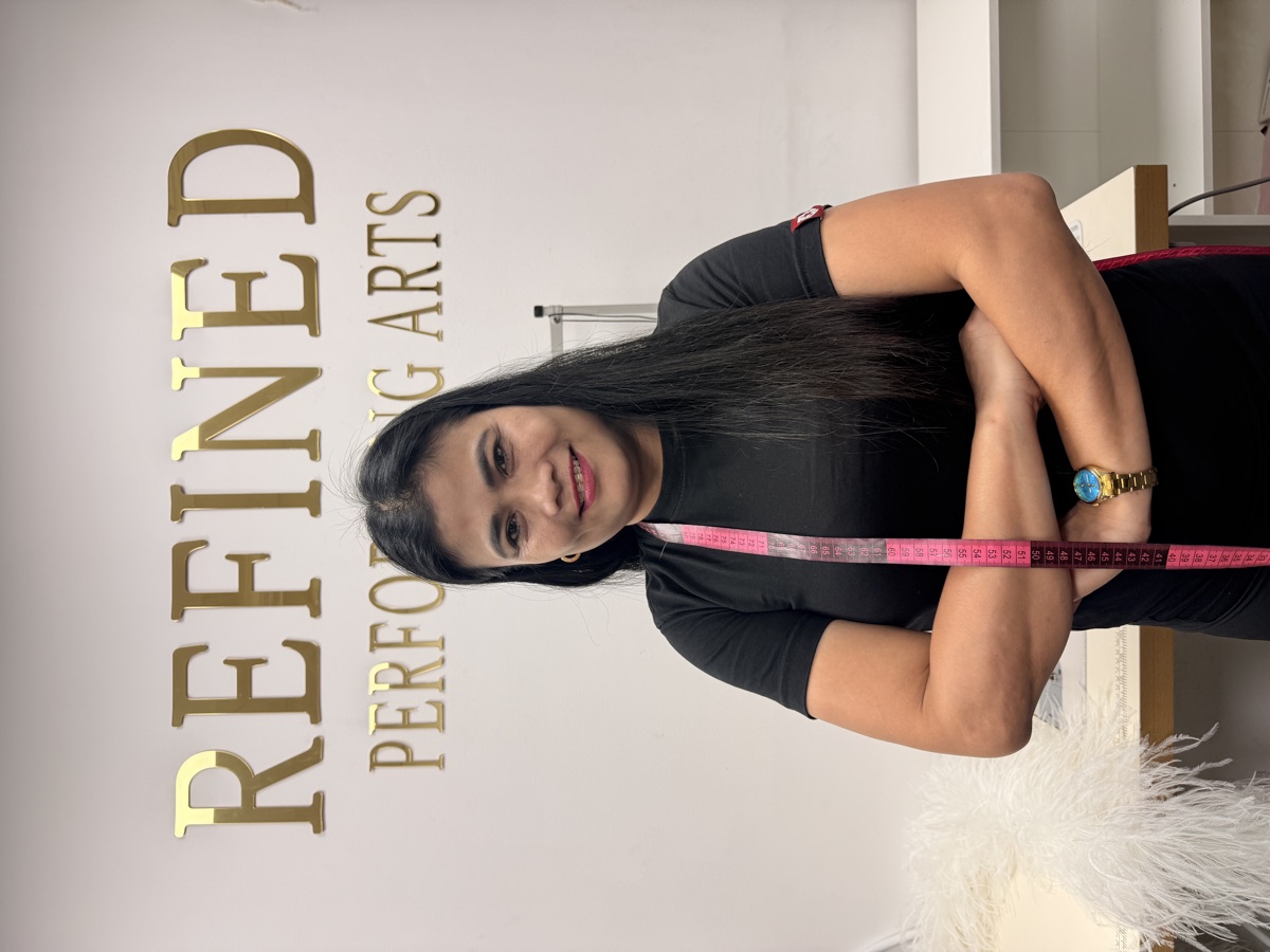Our tailor smiling with arms crossed in the atelier