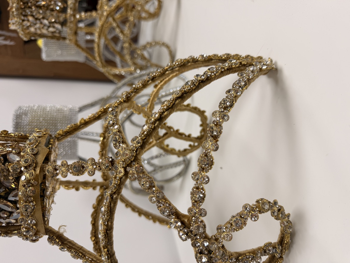 Handmade gold rhinestone headpiece frames on the atelier worktable