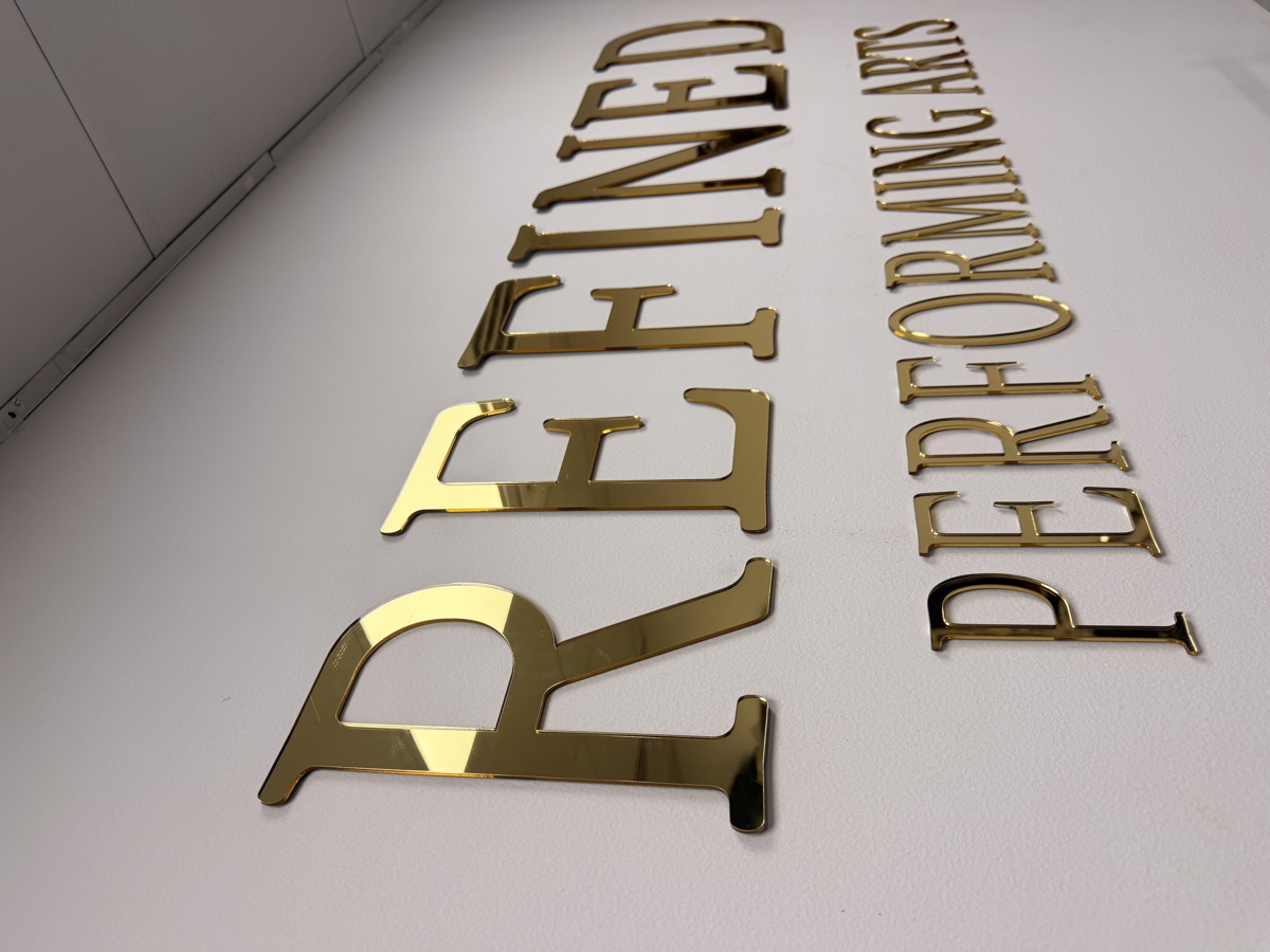 Polished gold Refined Performing Arts lettering on the atelier wall