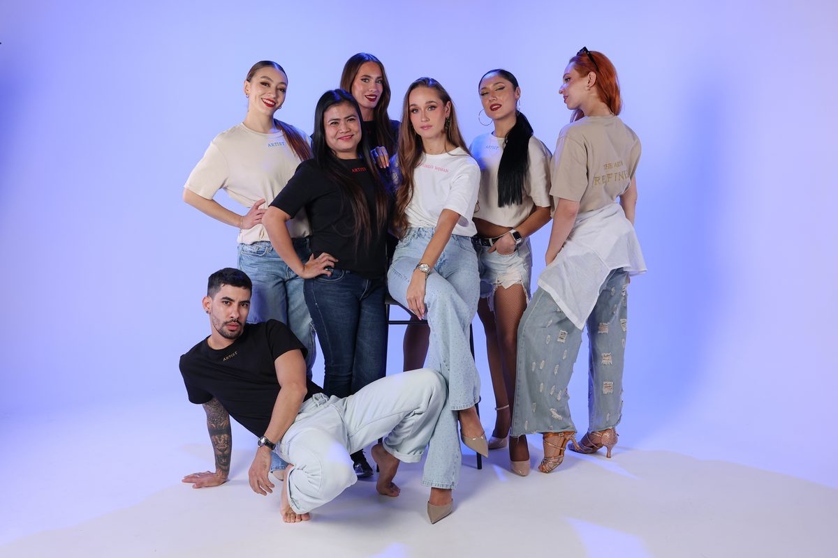 Dancers and team in casual wear in a second studio group pose