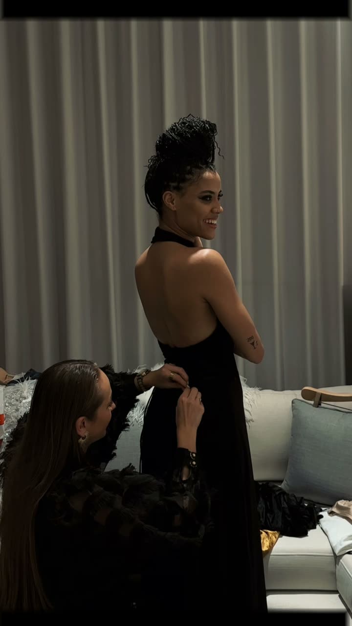 A performer being dressed and styled before a show